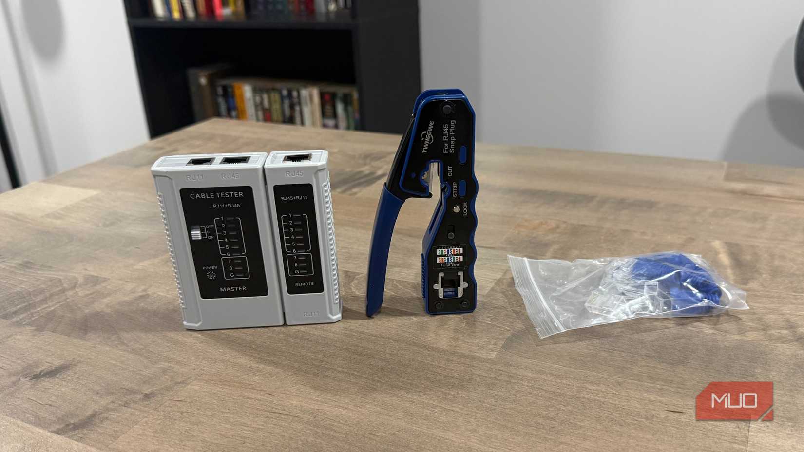 RJ45 crimping tool and tester on desk 