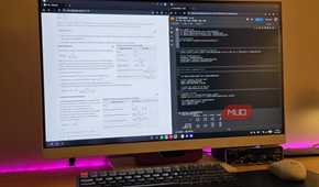 Samsung DeX running 2 Chrome windows with a keyboard and mouse on a table.