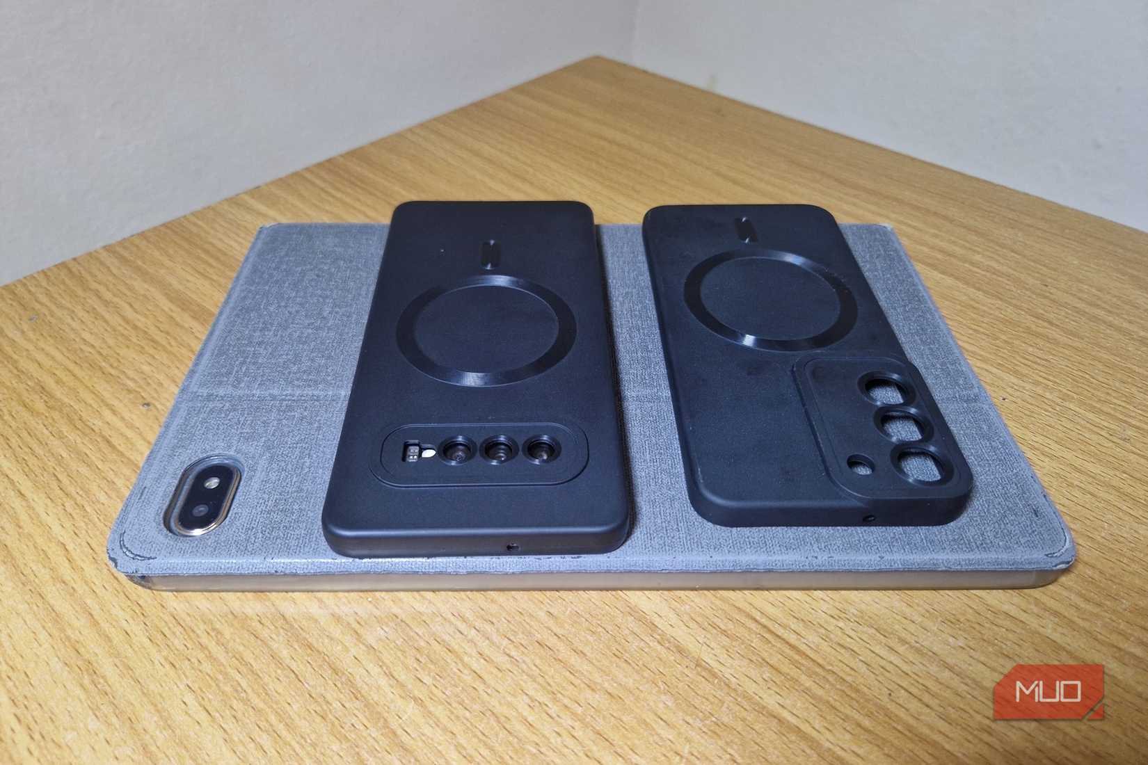 Samsung phone cases sitting on top of a tablet phone case