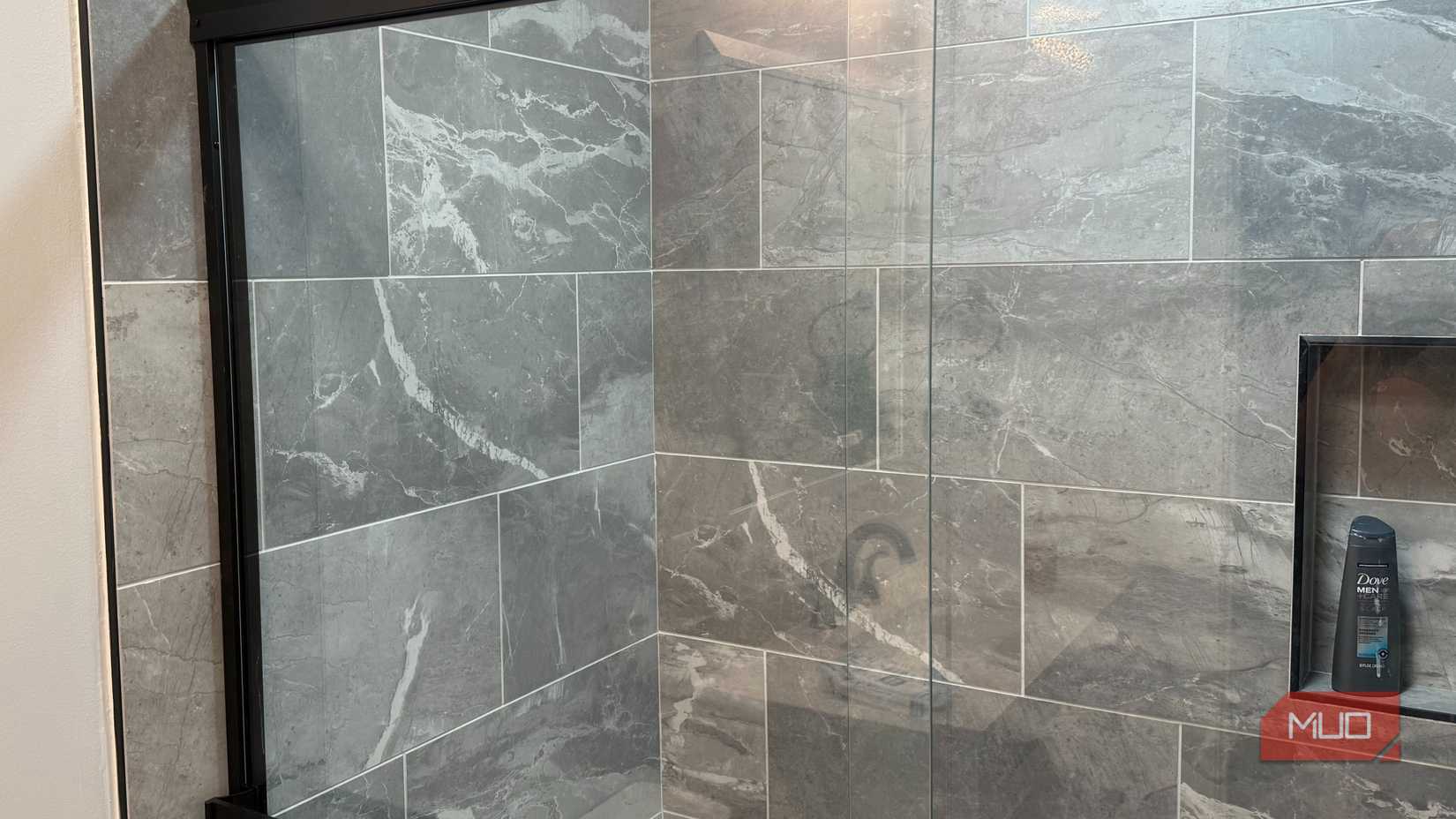 shower glass door with gray tile