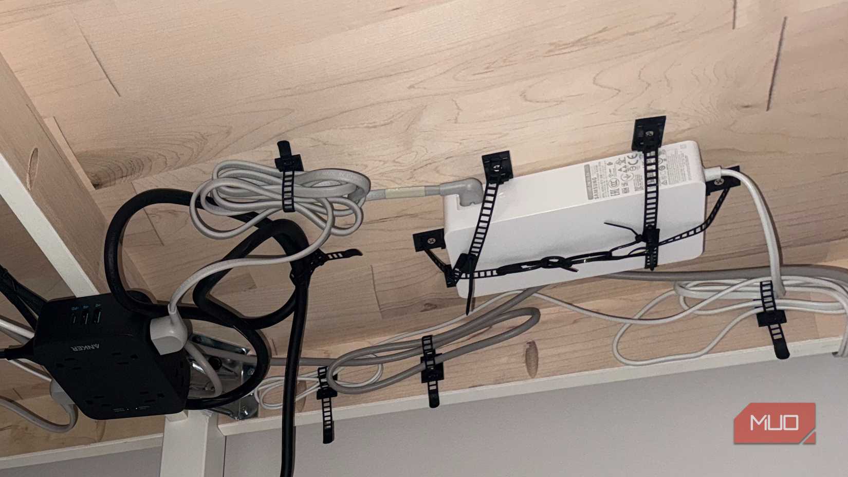 under desk mounting of cables with adhesive cable management clips
