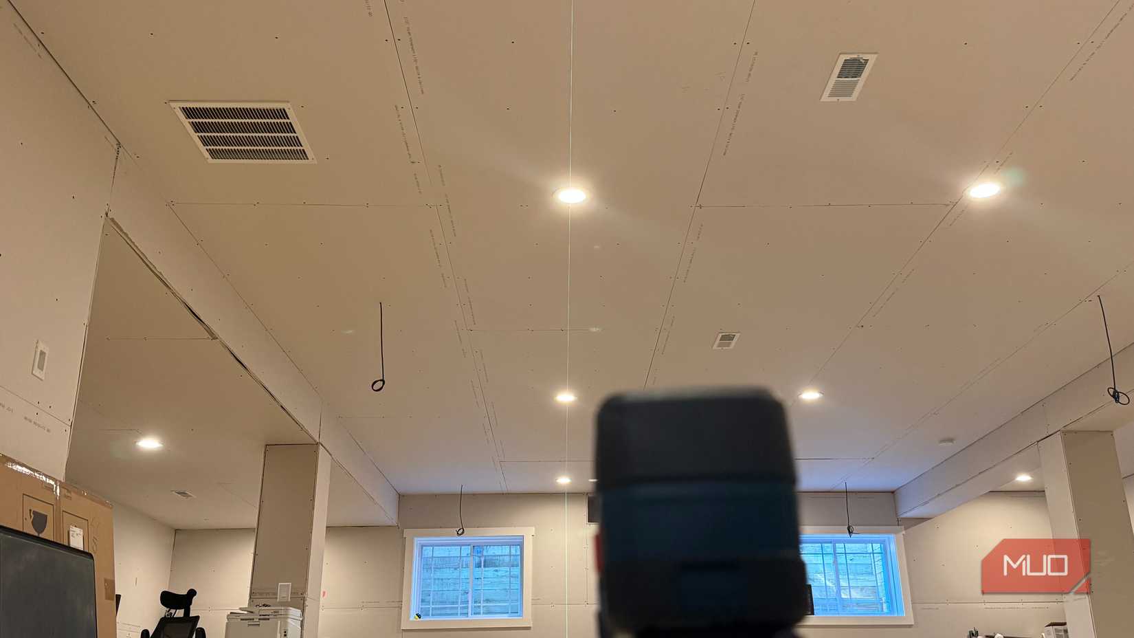 vertical green laser lining up can lights in ceiling