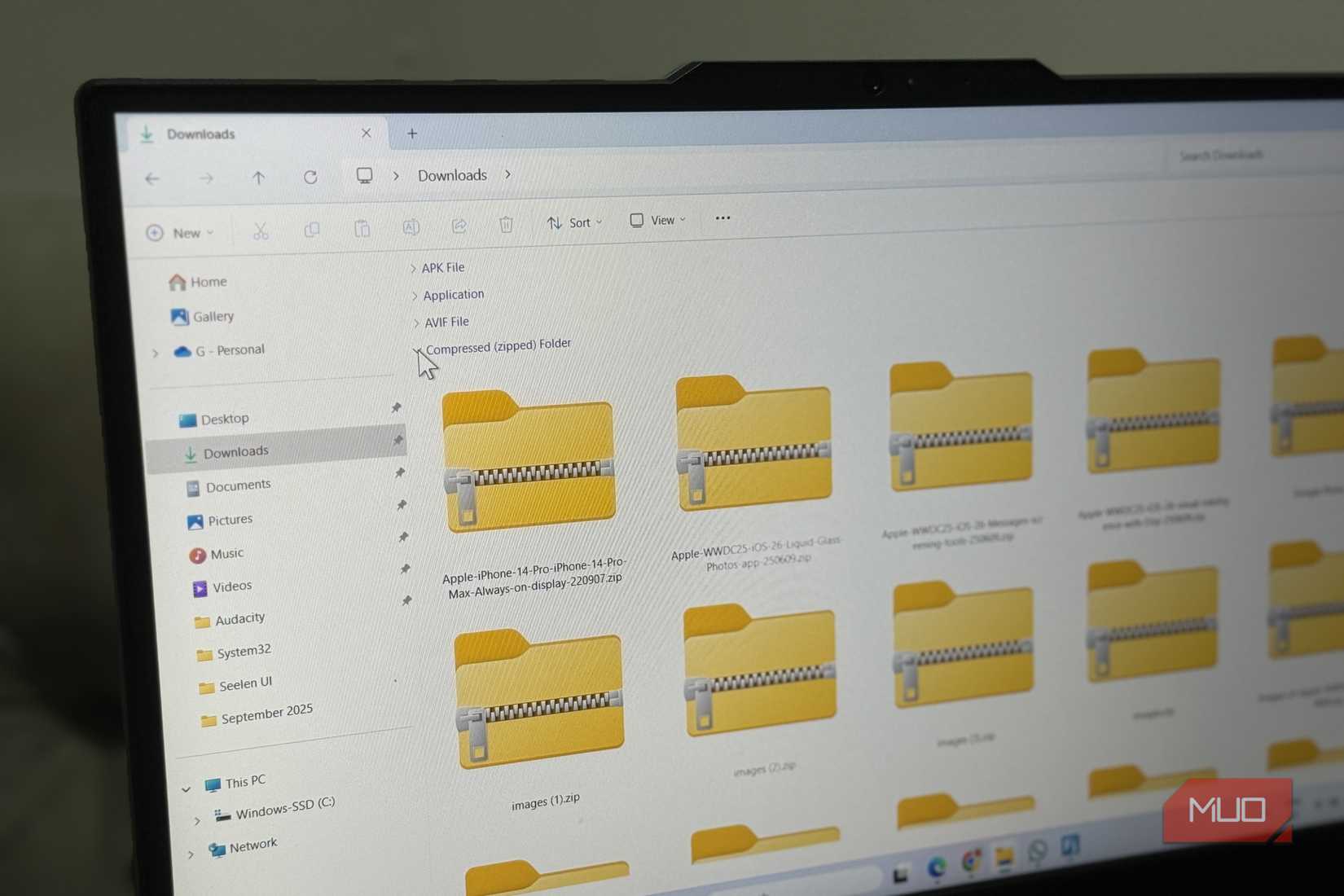 Windows laptop showing downloads folders with zip files