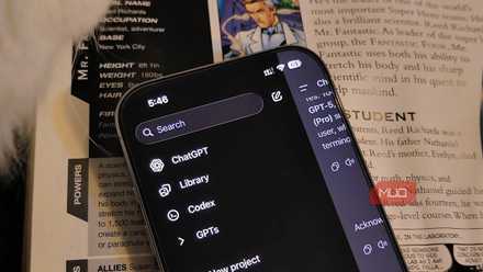 An iPhone with the ChatGPT app open on a book