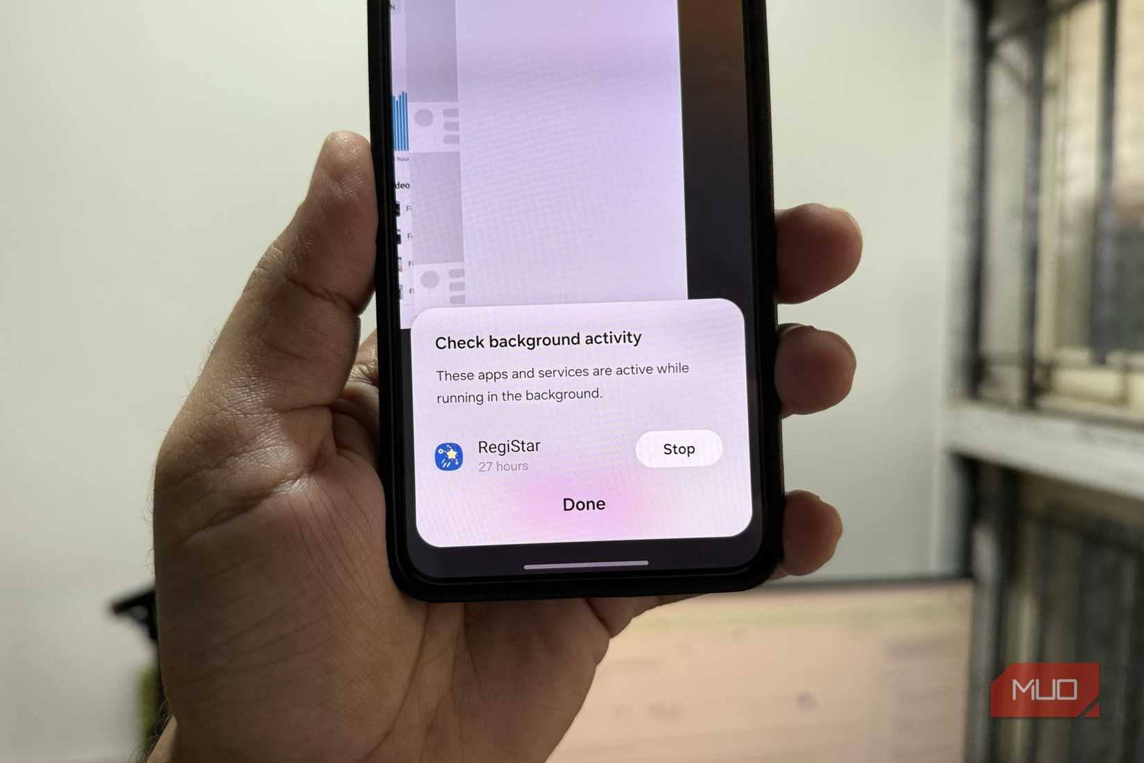 Android phone in hand showing background apps