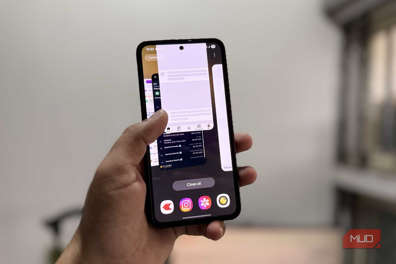Android phone in hand showing recents menu