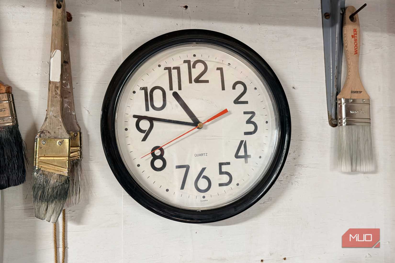A wall clock in a basement.