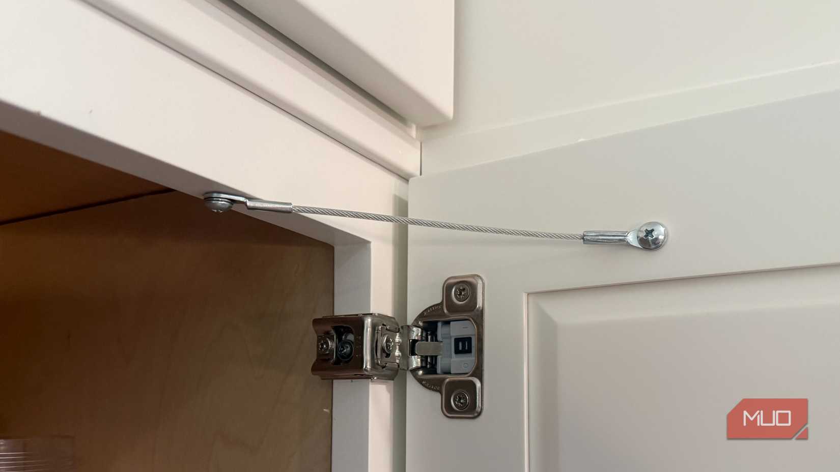 flexible cabinet door restraint on white door