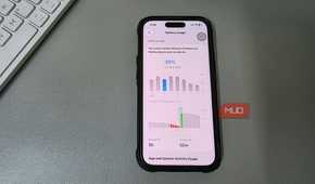 iPhone showing Battery Usage screen placed on a desk beside a keyboard.