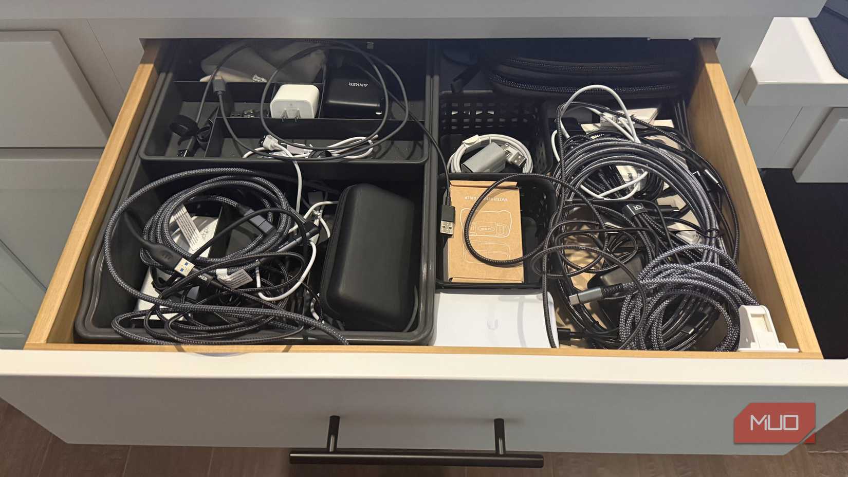 many charging cables in desk drawer