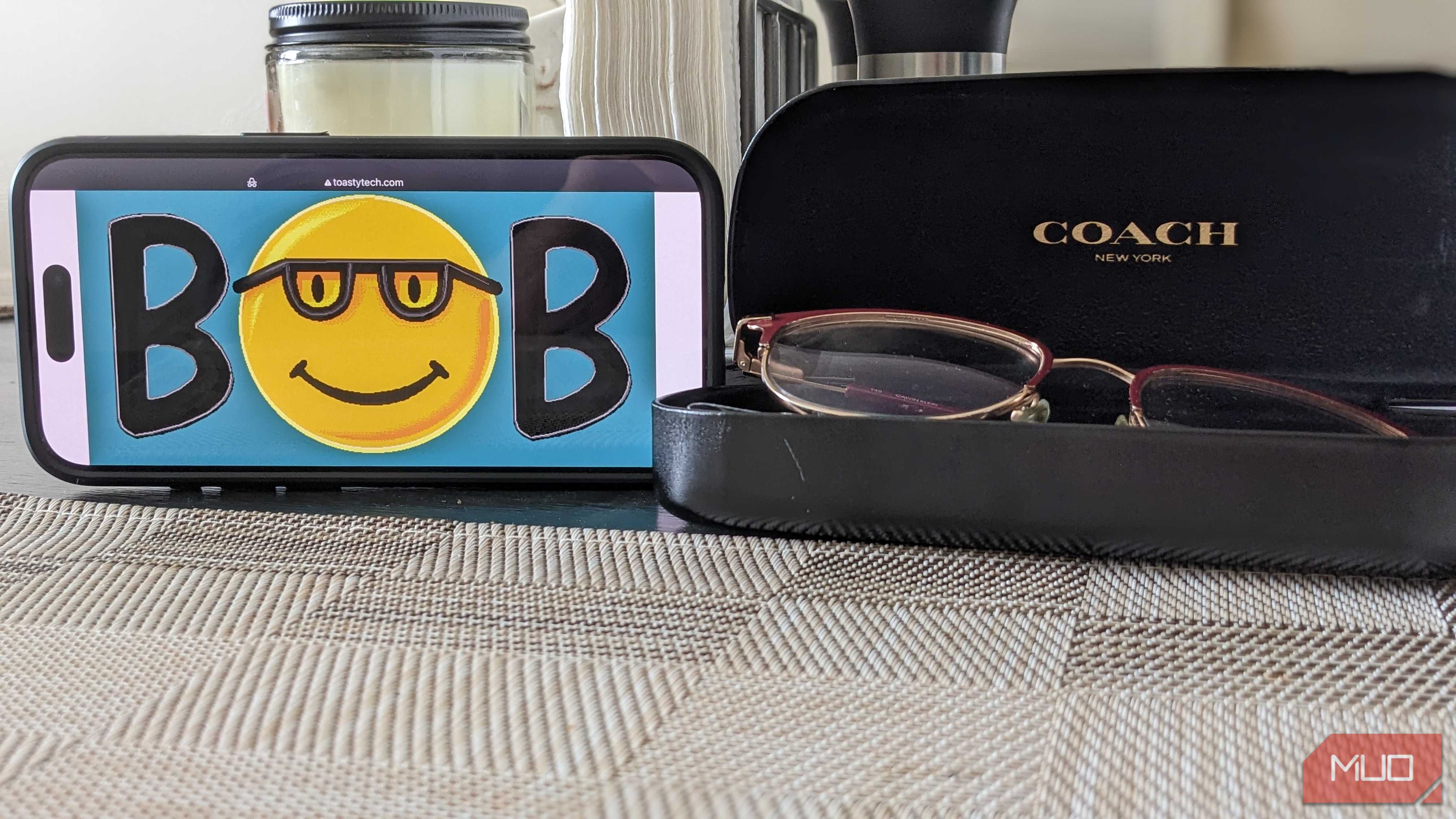 Microsoft Bob Logo on Phone Next to Glasses Case