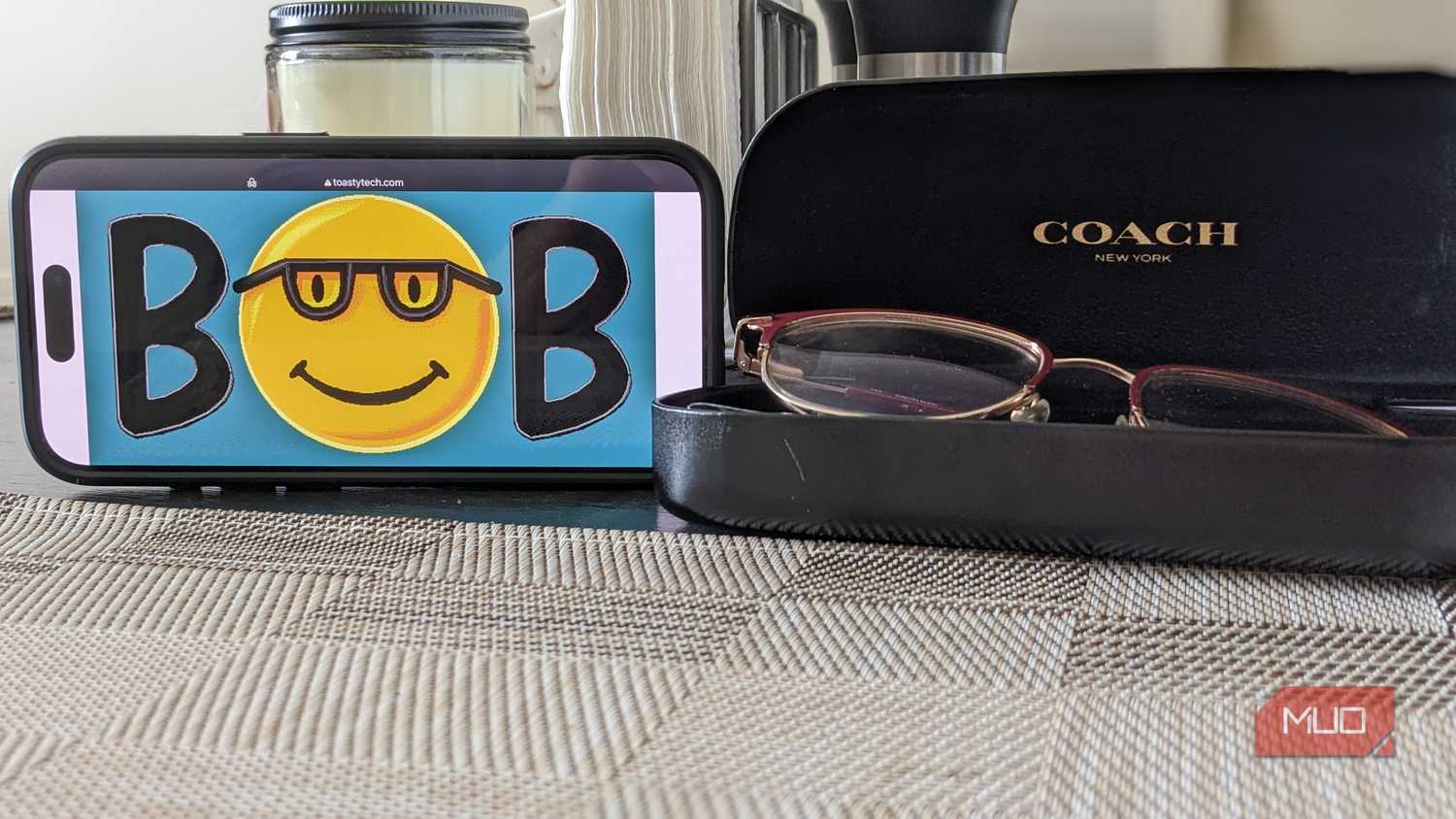 Microsoft Bob Logo on Phone Next to Glasses Case