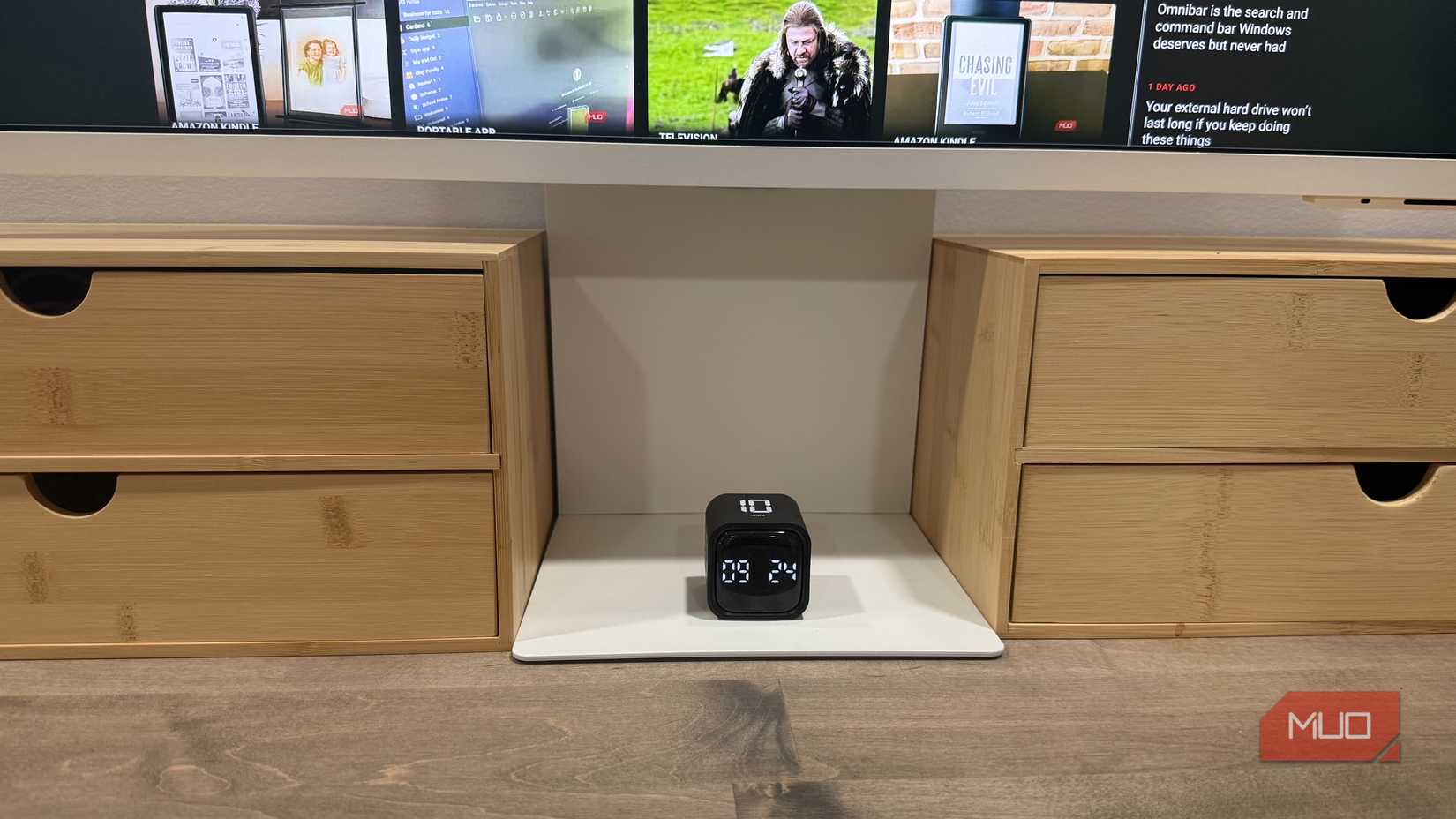 Pomodoro timer cube under monitor on desk