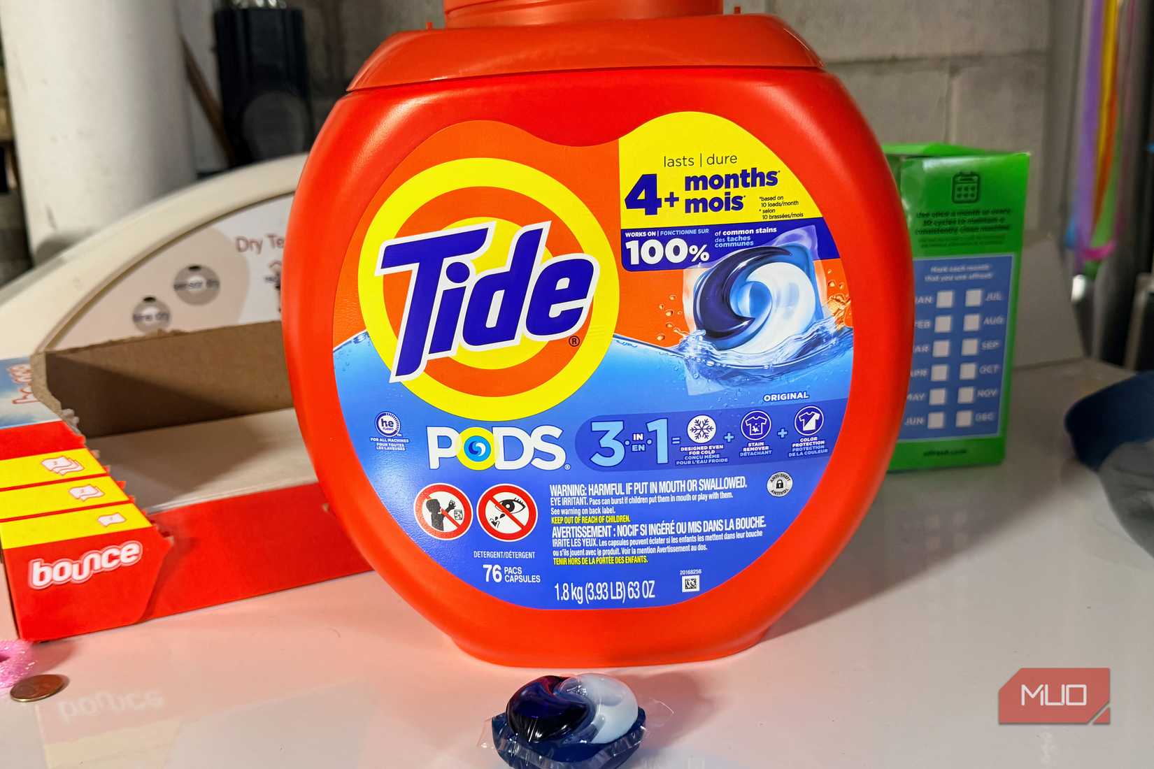 A container of Tide on a dryer.
