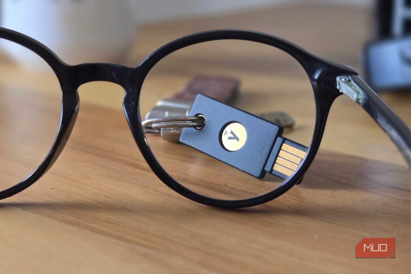 YubiKey security NFC seen through a glass lens kept on a wooden table