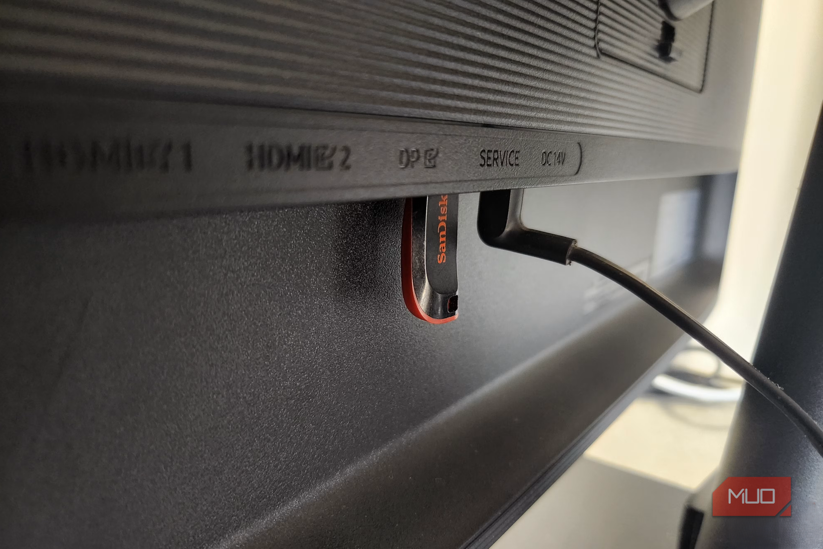 A black USB flash drive connected to monitor
