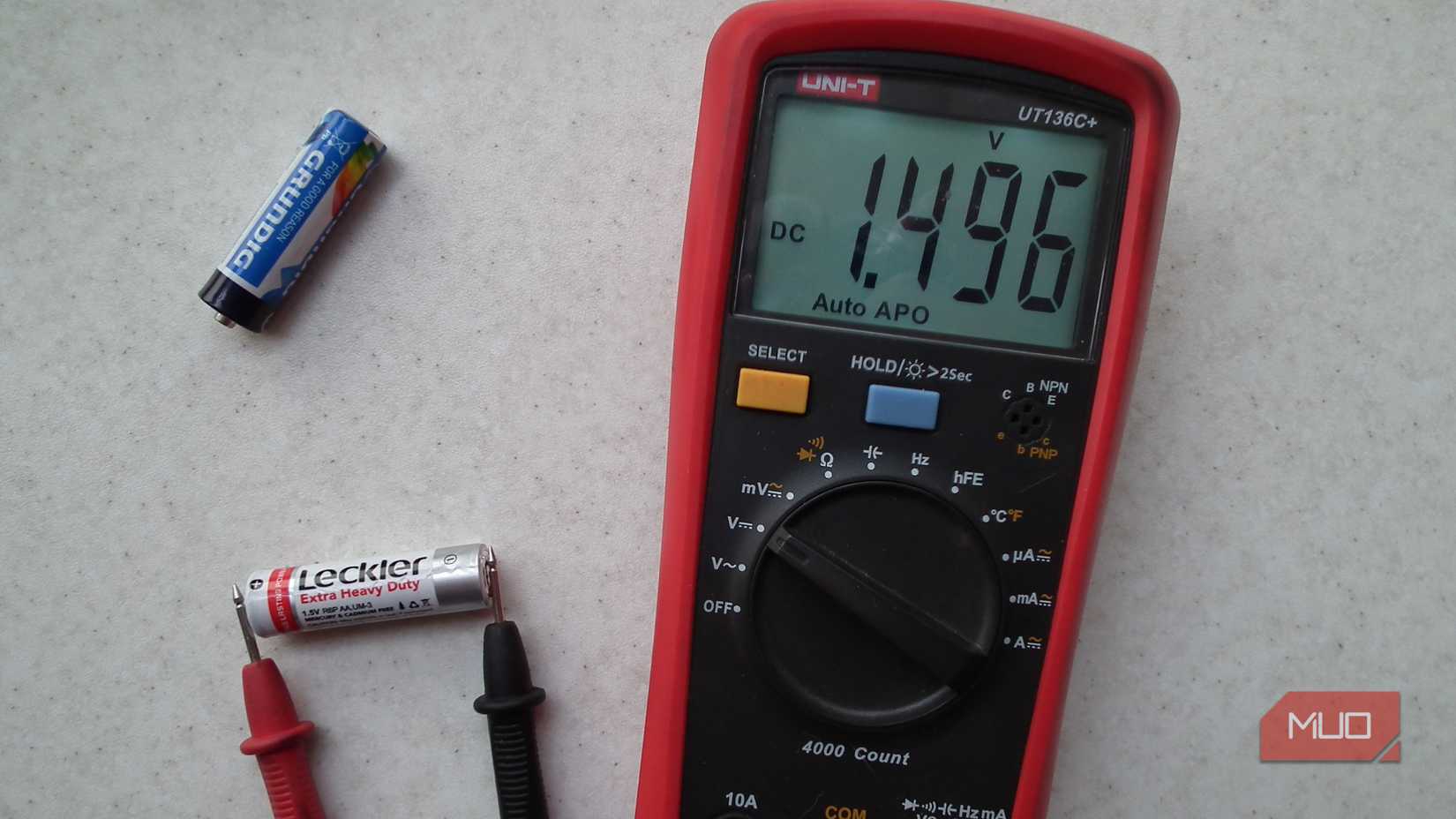 A multimeter measuring the voltage of an AA battery