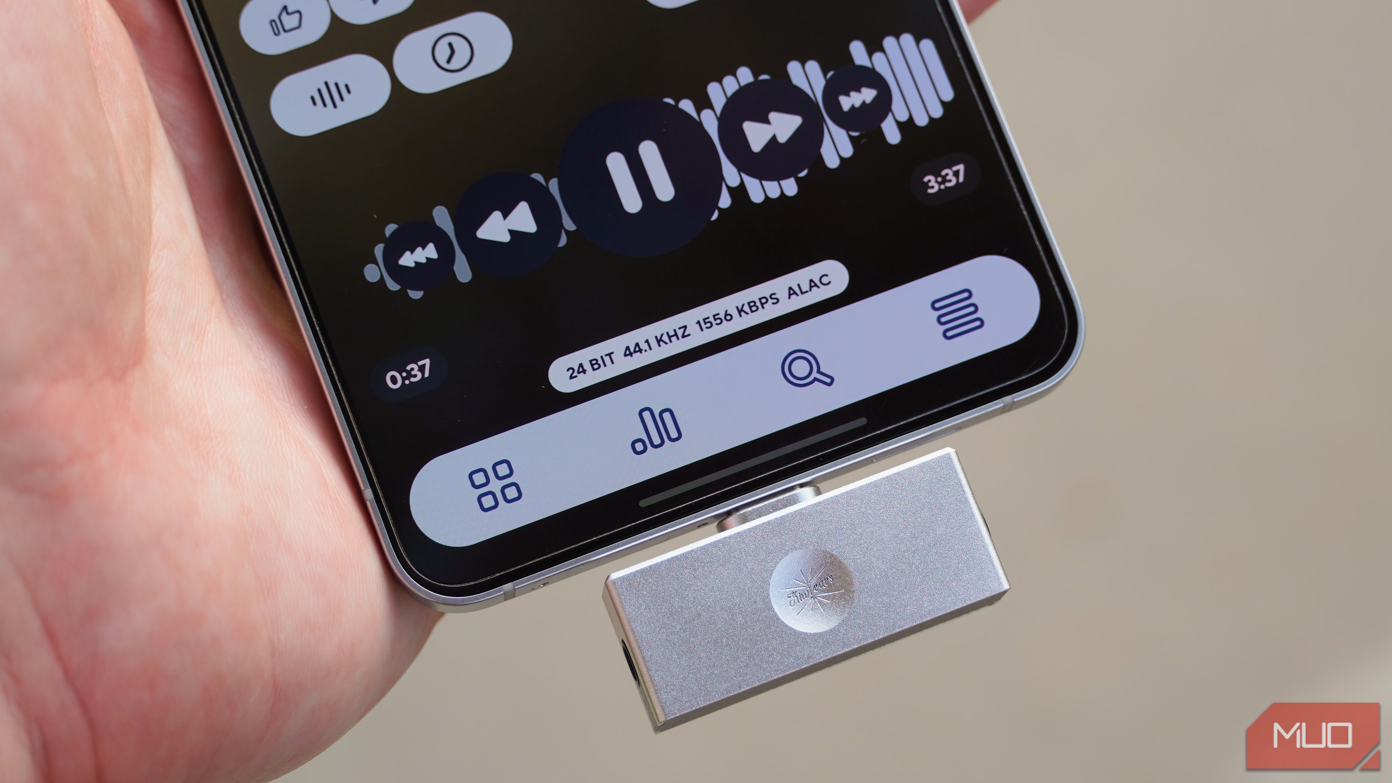 A USB-C DAC plugged into an Android phone playing ALAC music files.
