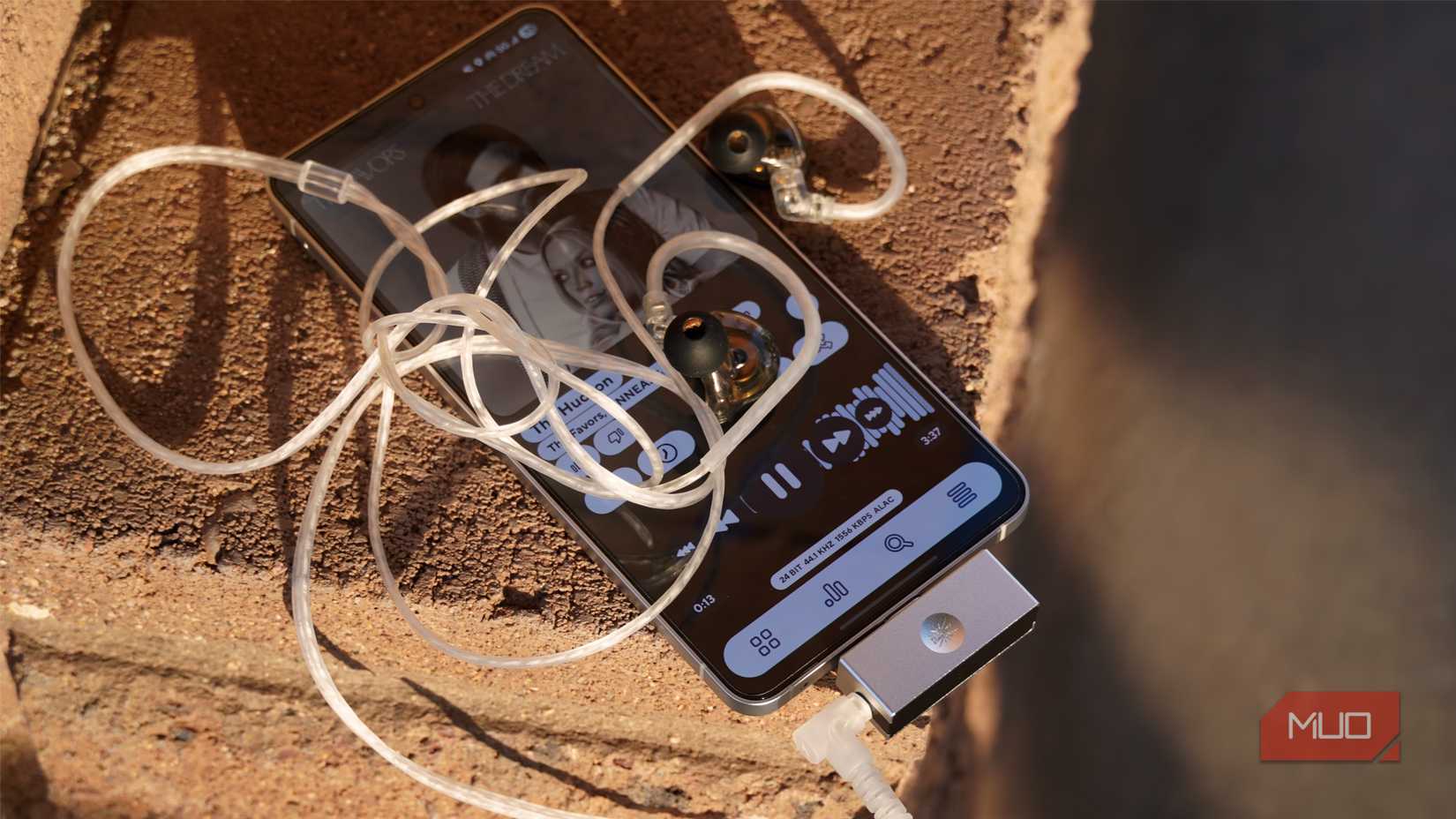 A USB-C DAC and headphones connected to a Galaxy S25 Edge.