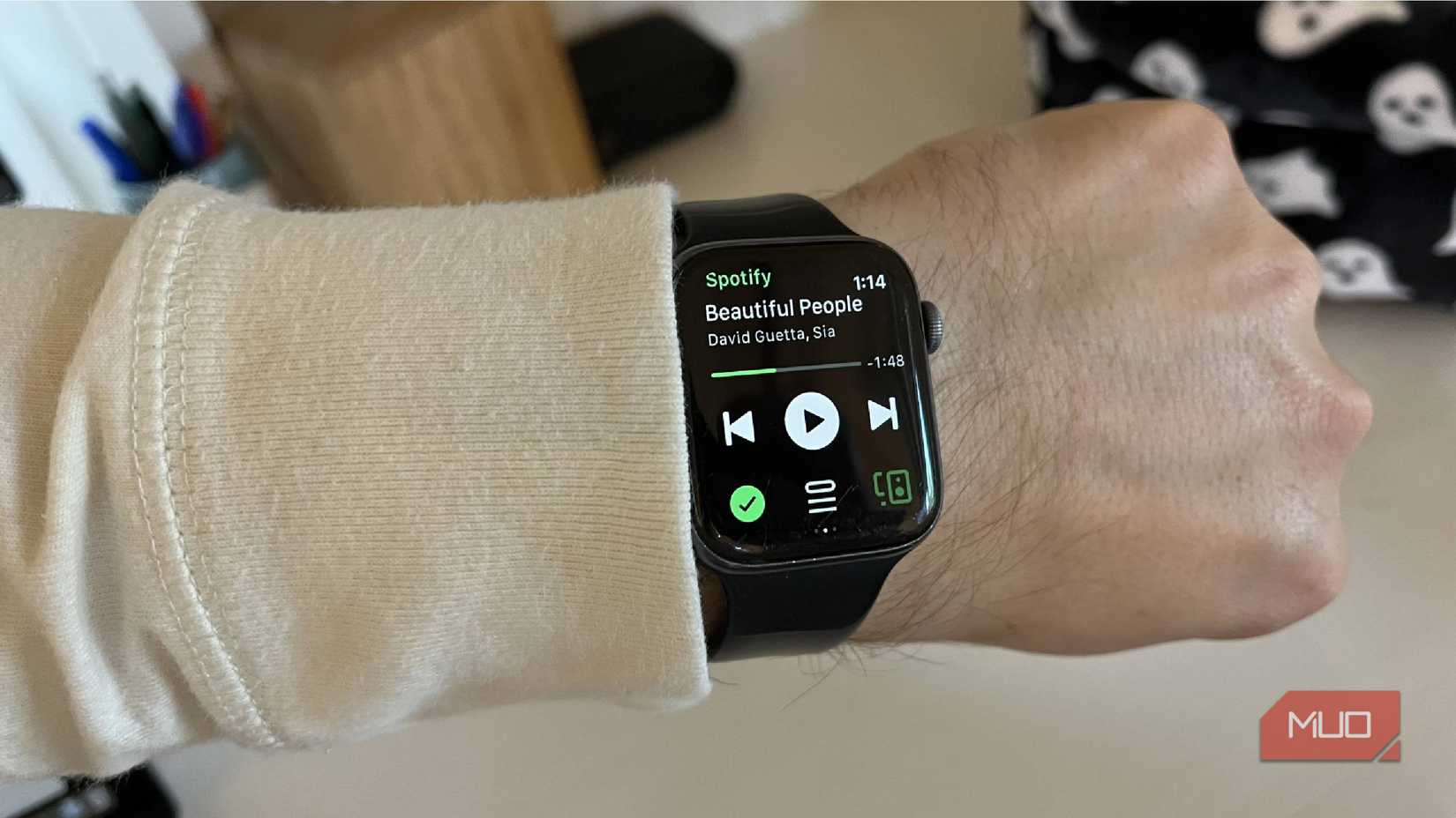 An Apple Watch showing Spotify controls