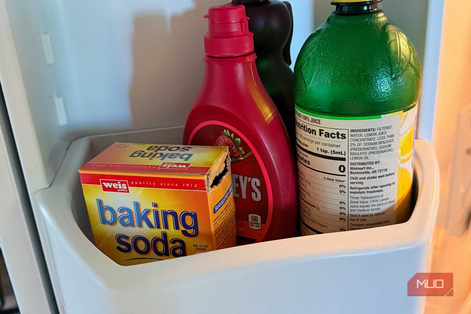 Baking soda and other items in a refrigerator.