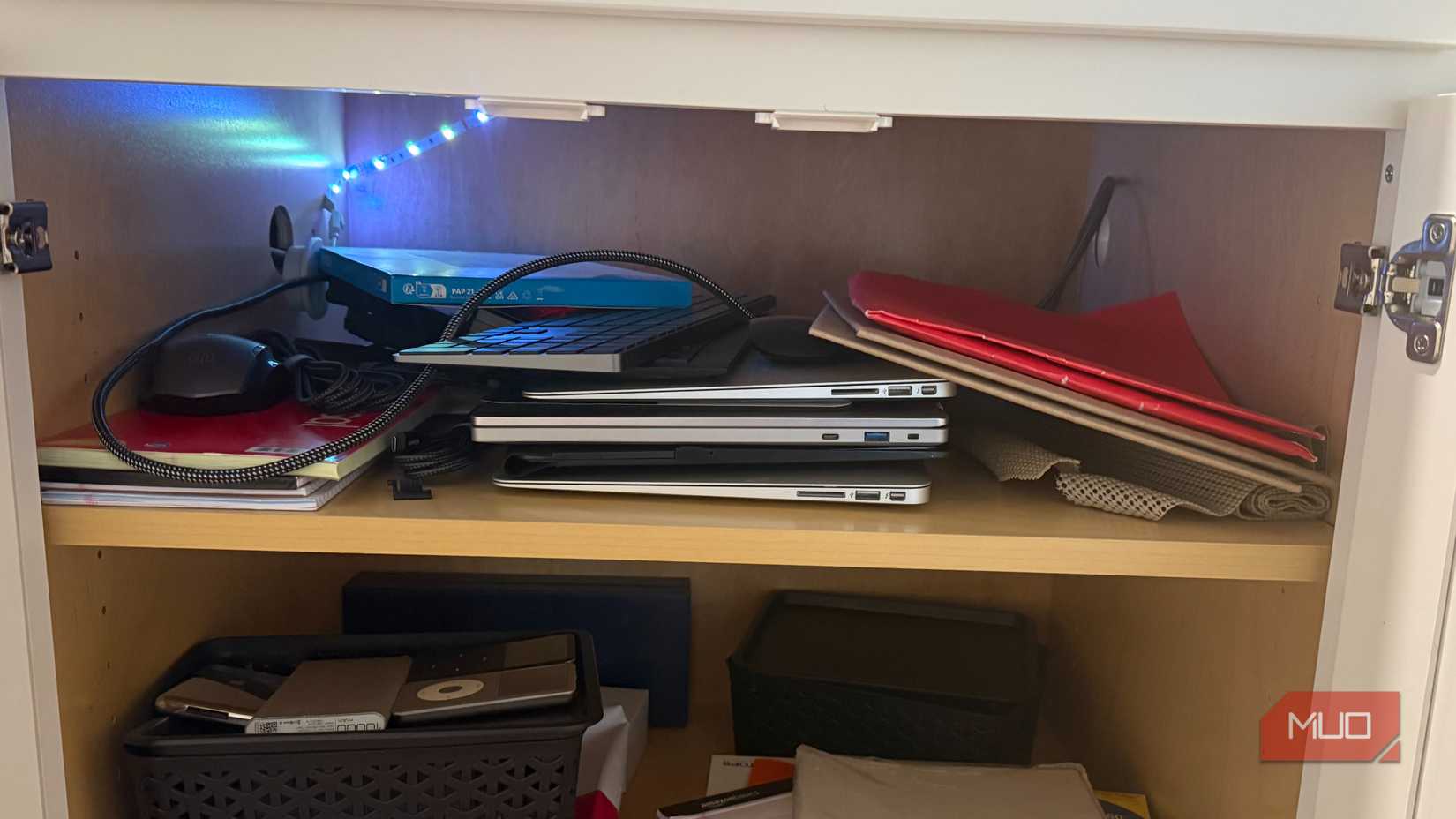 chromebook and macbook airs stored in cabinet