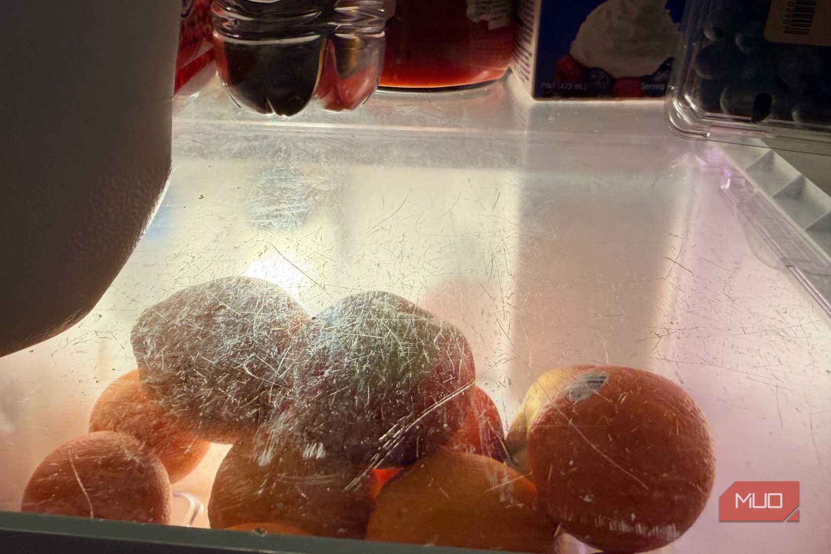 A closeup of dirty shelving inside a refrigerator.