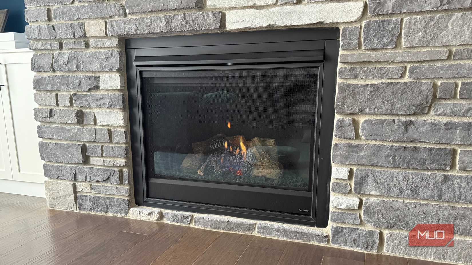 gas fireplace light in grey stone wall