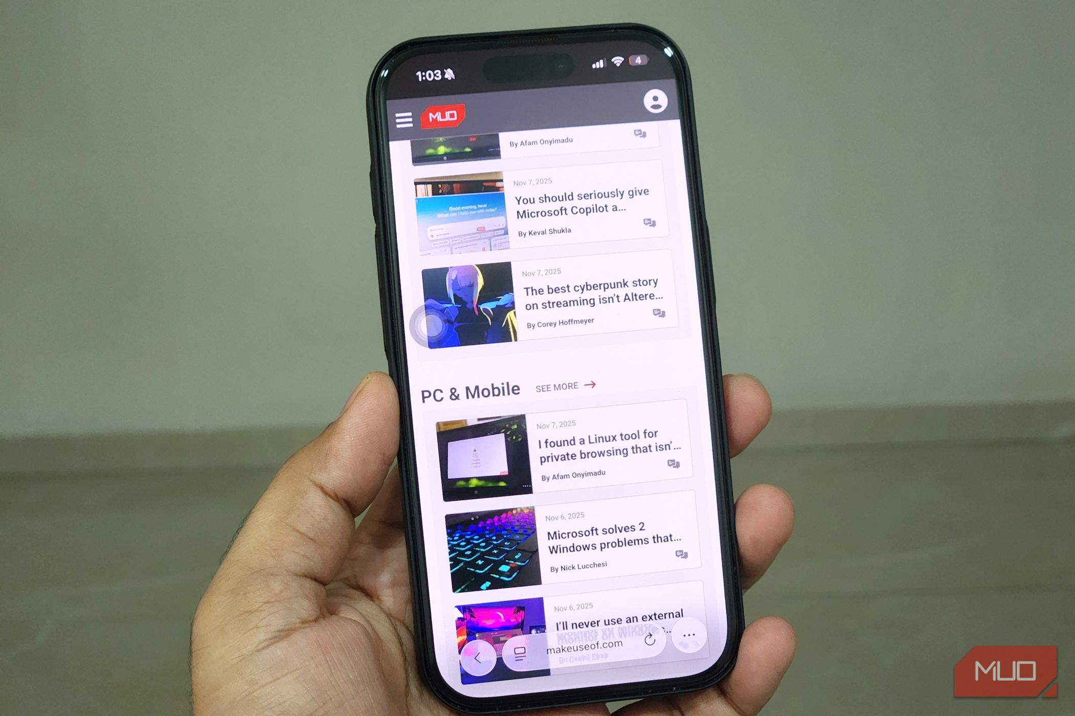 iPhone in hand showing Safari