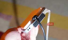 A MagSafe battery pack, DAC, charger, and headphones plugged into a phone.