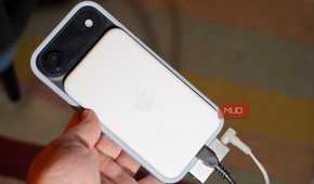A MagSafe battery pack, DAC, charger, and headphones plugged into a phone.