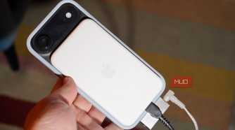 A MagSafe battery pack, DAC, charger, and headphones plugged into a phone.