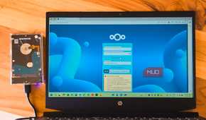 NextCloud login open on a HP laptop kept on a wooden table with an external HDD connected