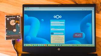 NextCloud login open on a HP laptop kept on a wooden table with an external HDD connected