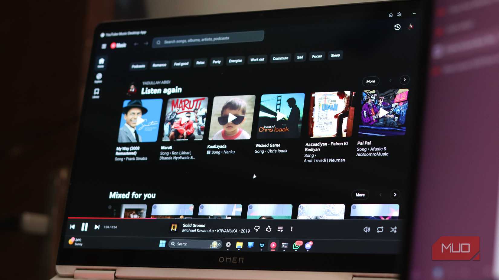OLED laptop display running YouTube Music.