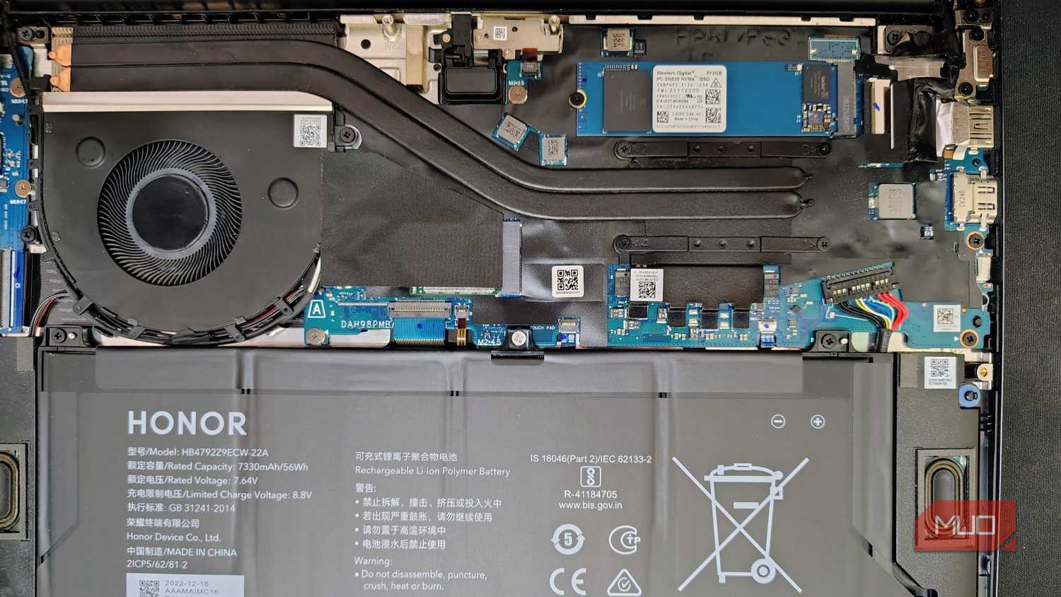 Open laptop back with motherboard and battery visible