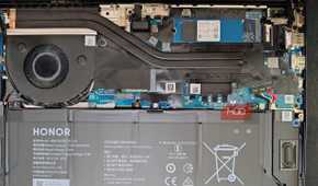 Open laptop back with motherboard and battery visible