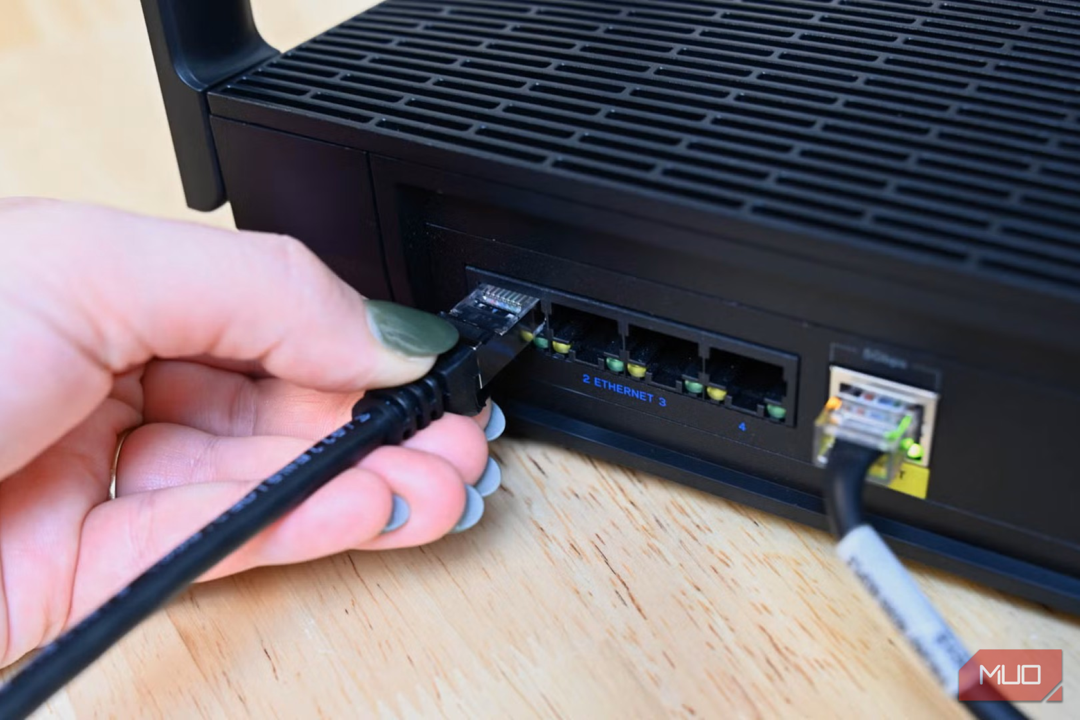 Person plugging in the Cable Matters ethernet cable into a router
