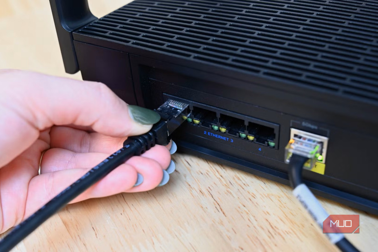 Person plugging in the Cable Matters ethernet cable into a router