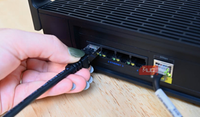 Person plugging in the Cable Matters ethernet cable into a router