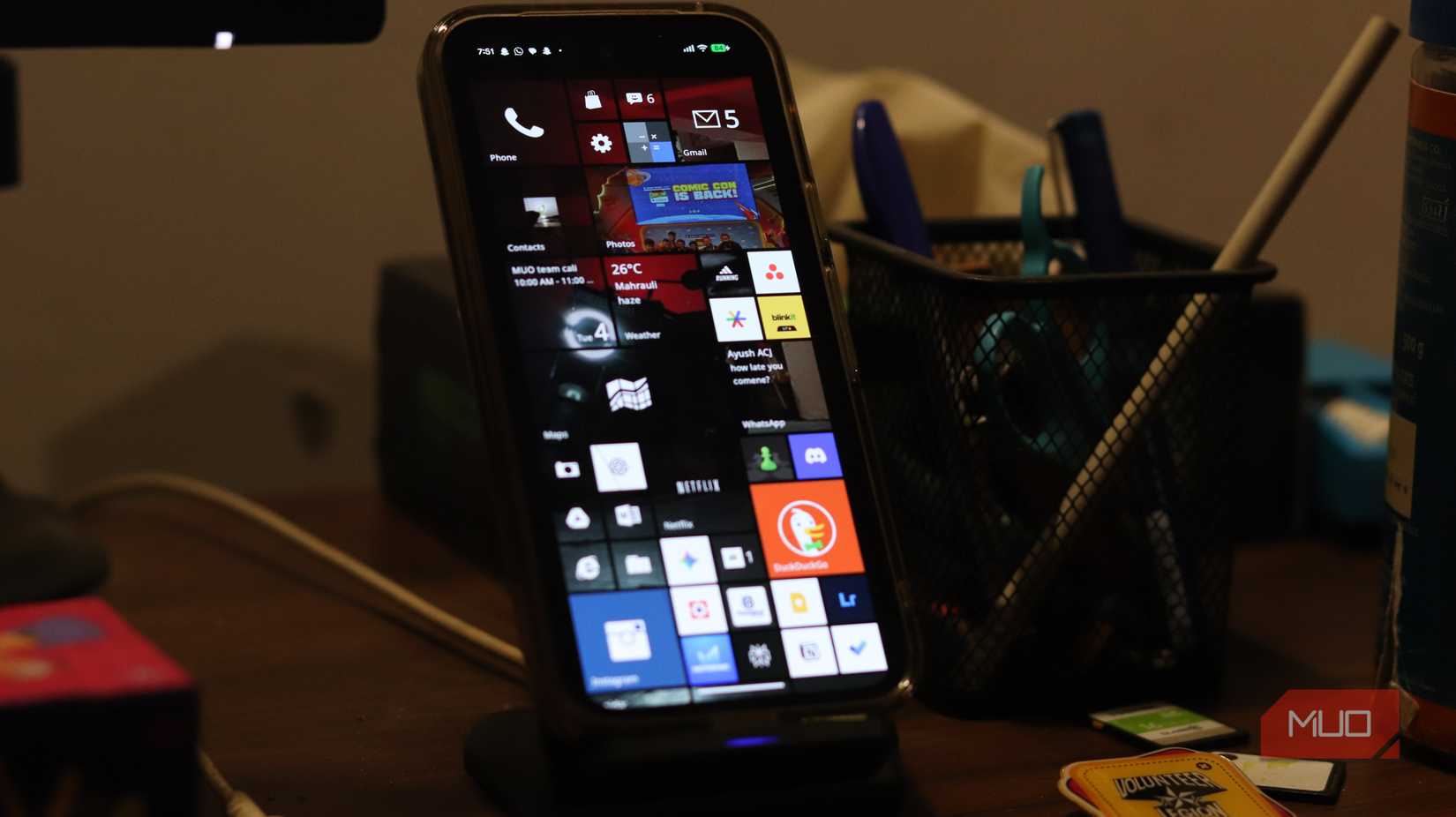 Pixel 9a on wireless charging stand running Metrov launcher.