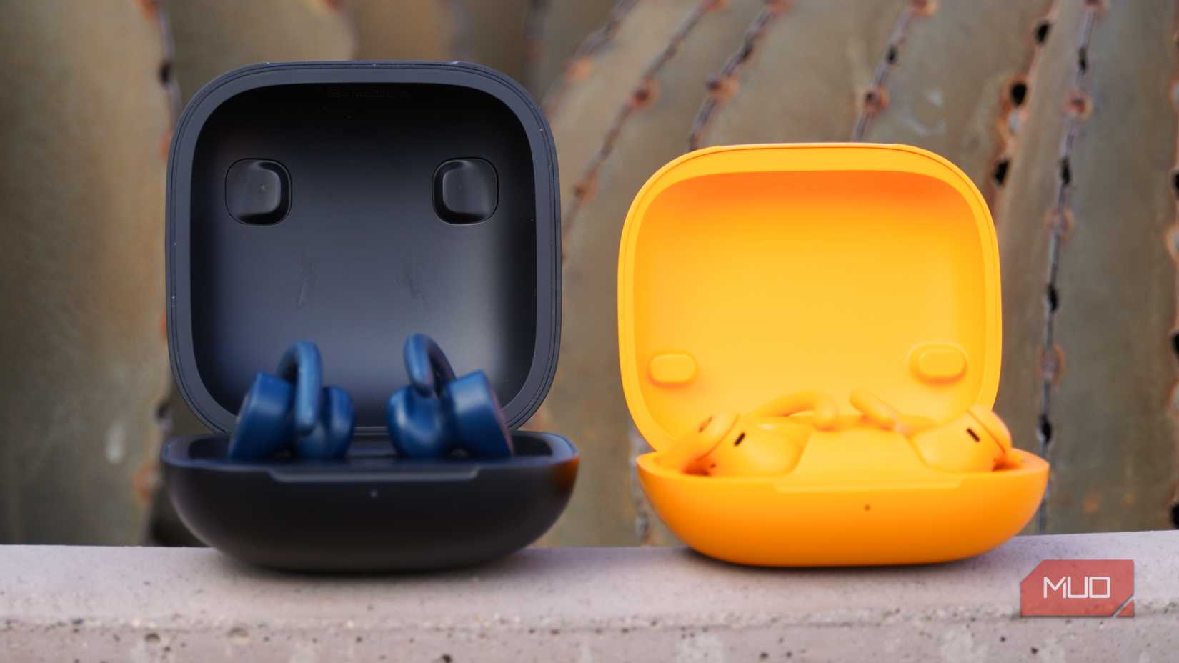 The two generations of Powerbeats Pro in their case.