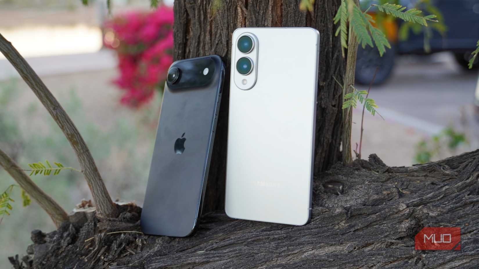 The iPhone Air and Galaxy S25 Edge leaning against a tree branch.