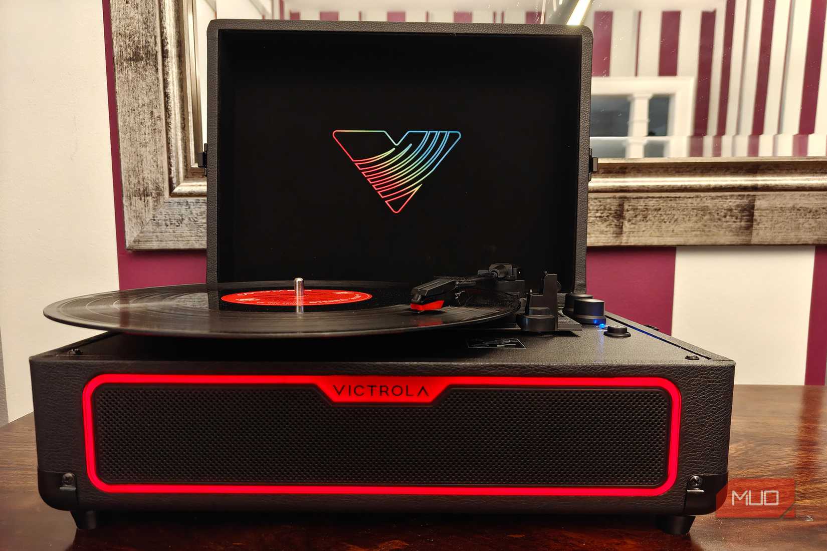 The front view of the Victrola Journey Glow record player with the light glowing red.