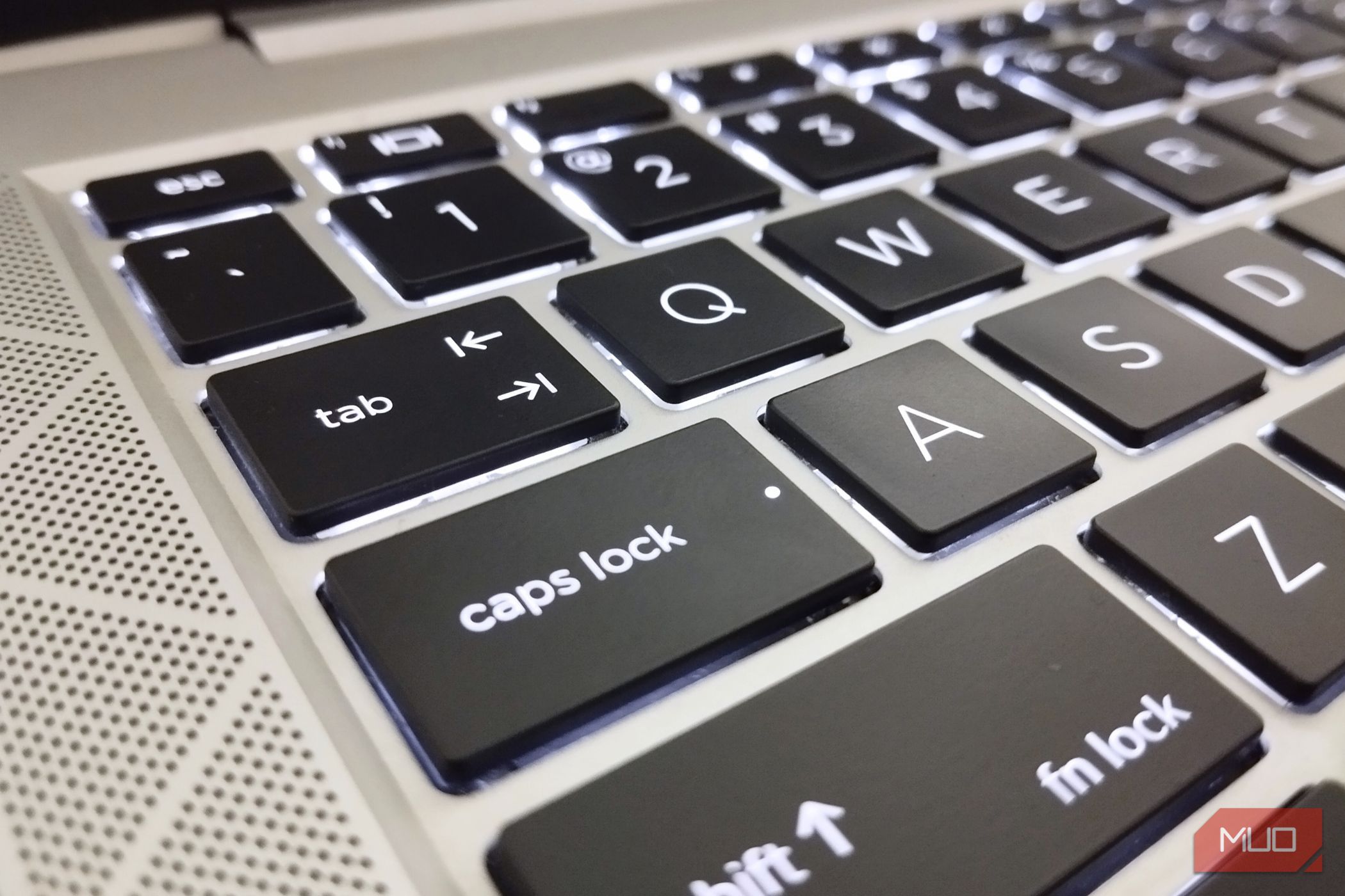 A backlit laptop keyboard focusing on caps lock.