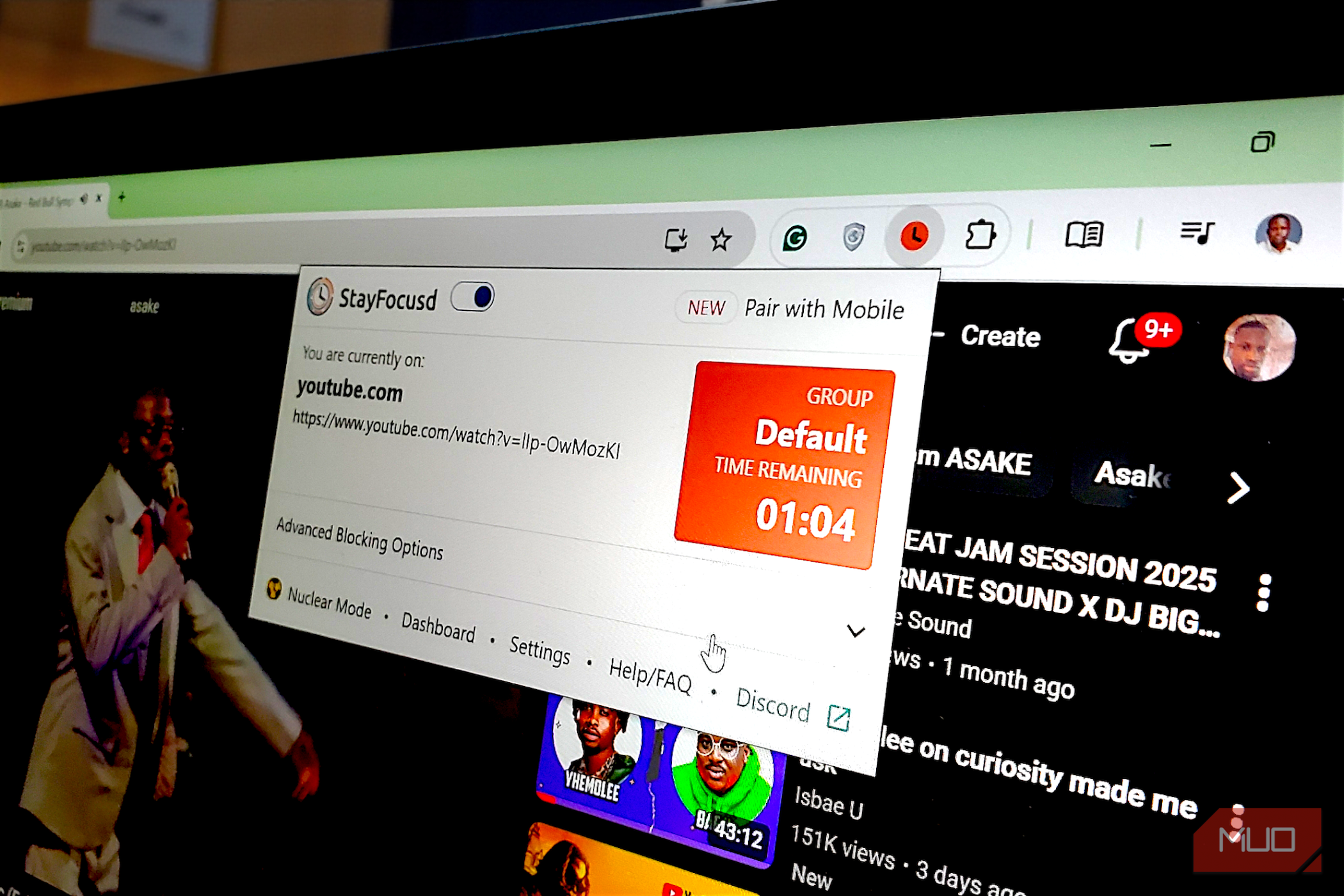 A laptop screen displaying the StayFocusd browser extension overlay with a countdown timer active on a YouTube video.