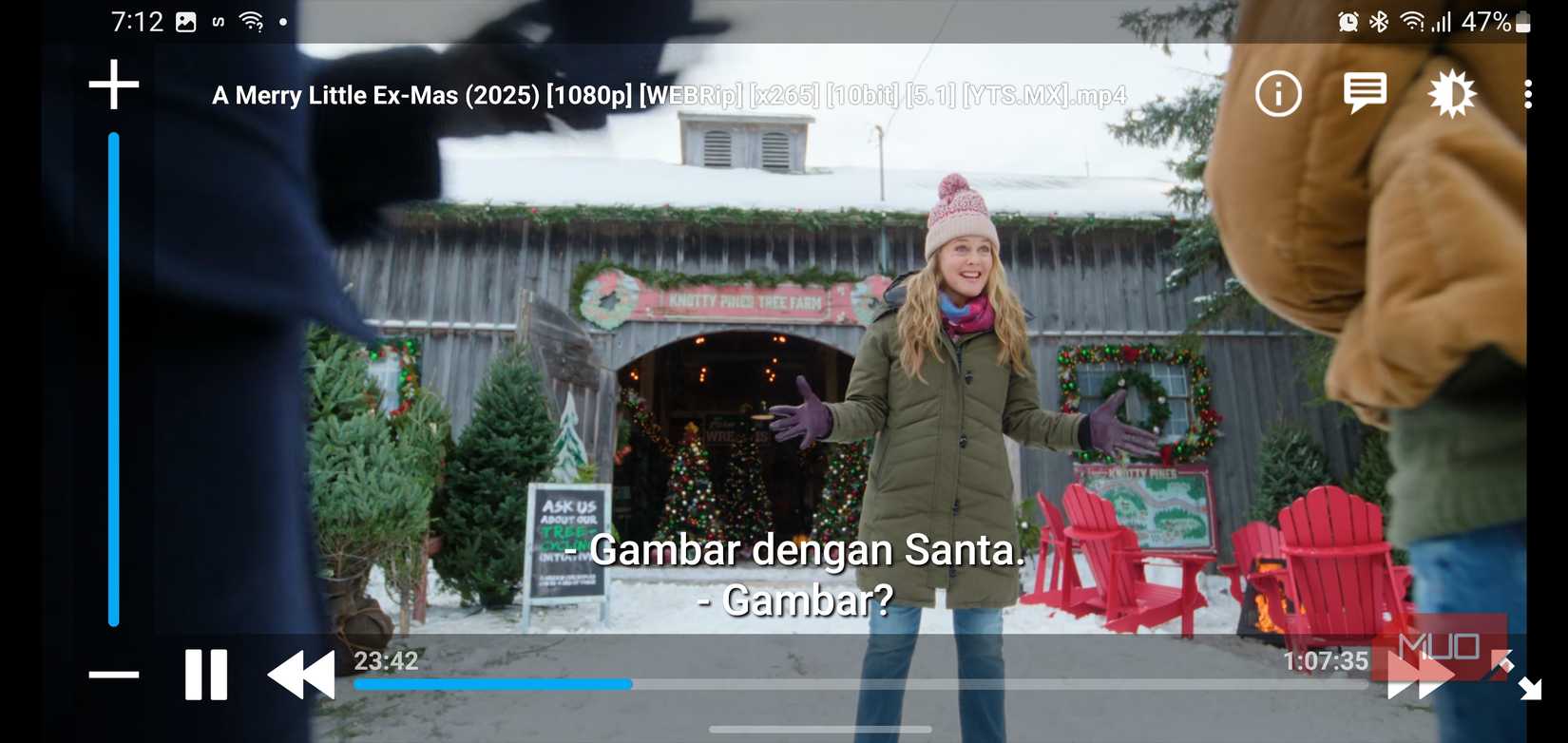 A scene from A Merry Little Ex-Mas playing in Nova Video Player with visible subtitles.