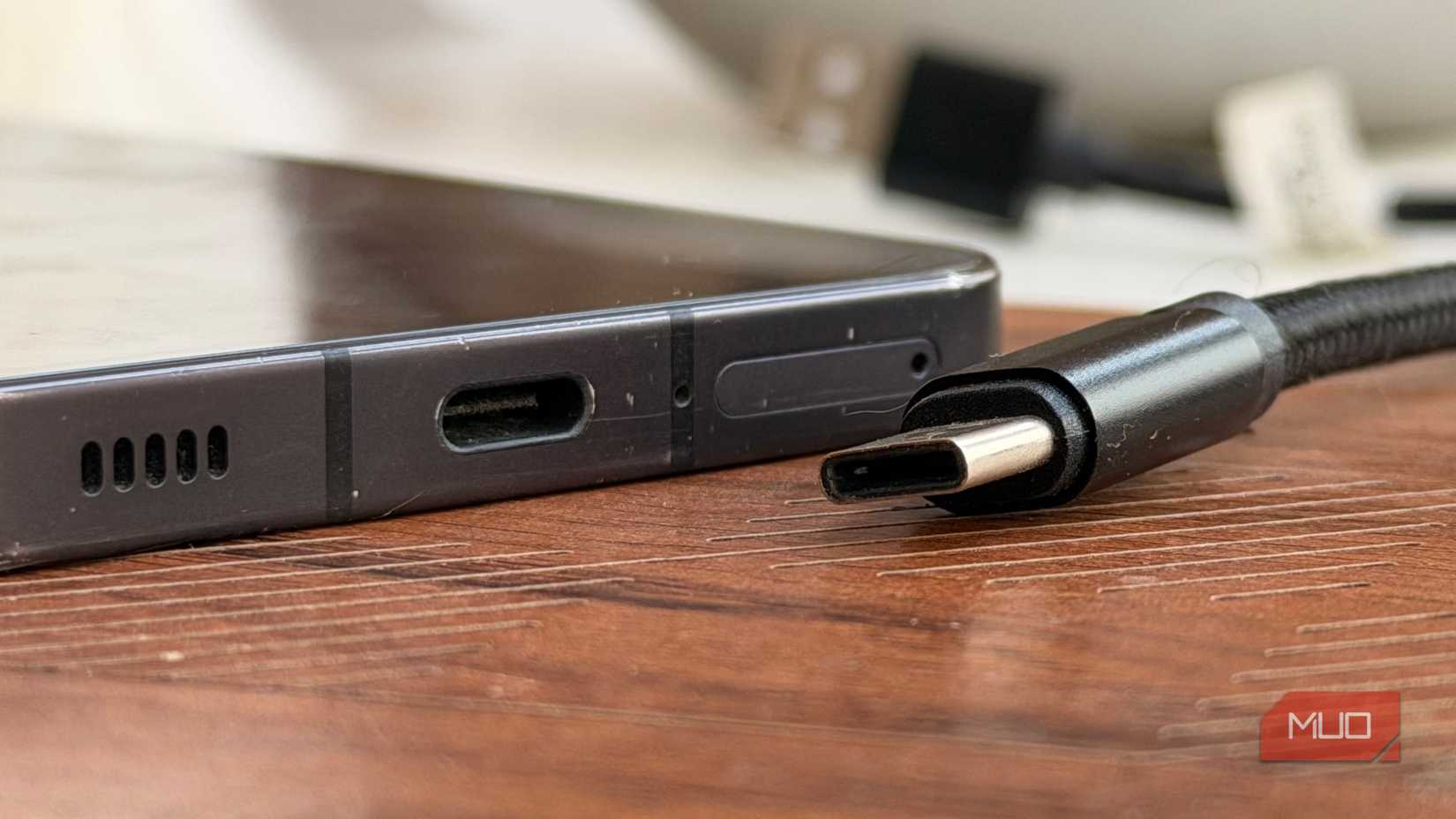 A USB-C plug next to the USB-C port of a phone (2)