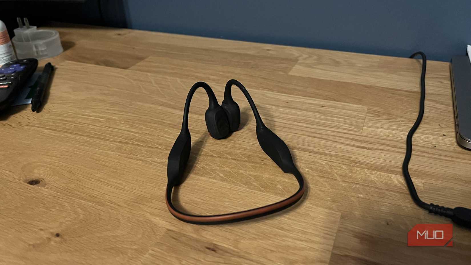 A pair of Philips A7607 bone conduction headphones on a desk