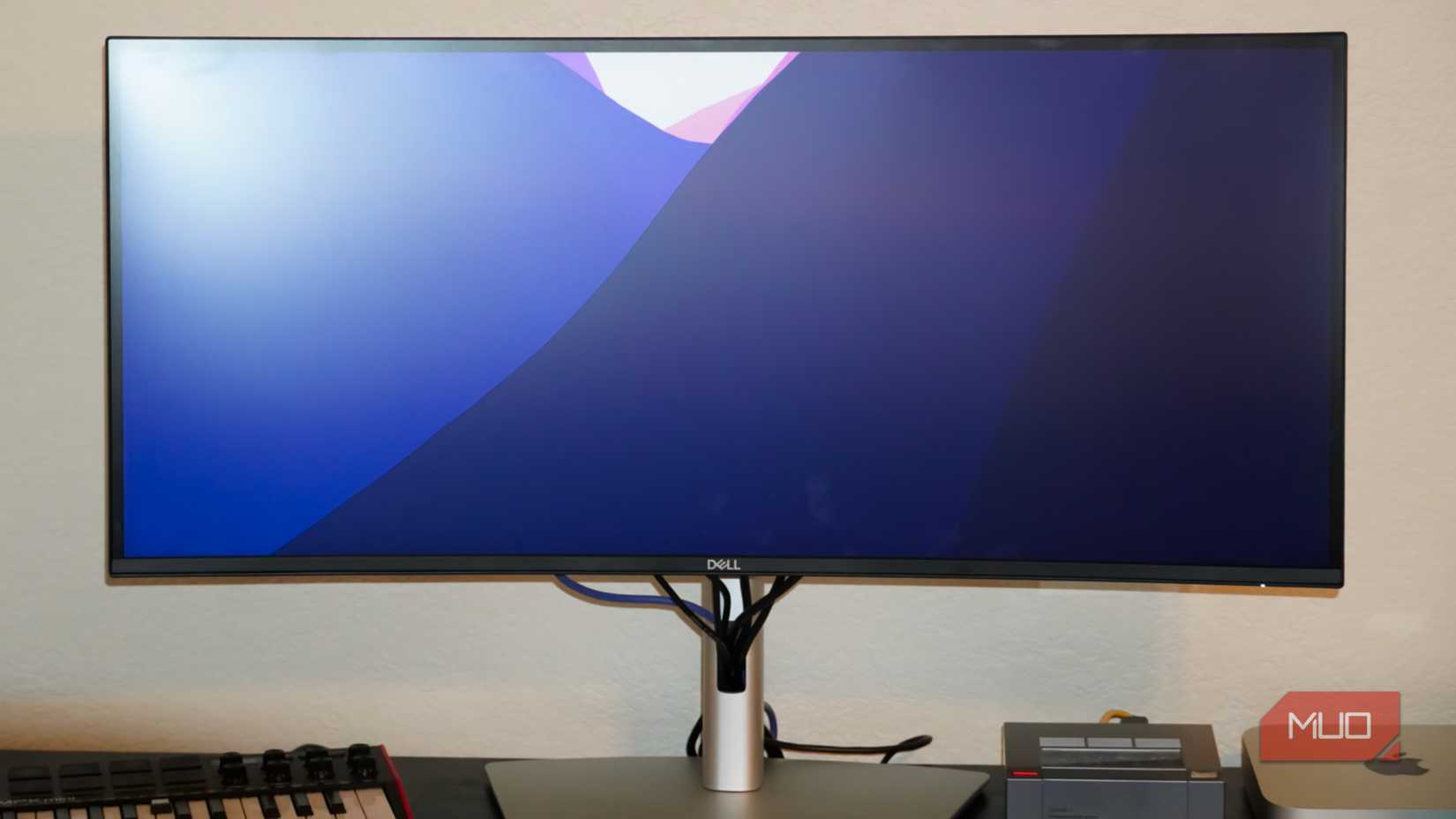 A macOS wallpaper on a Dell monitor.